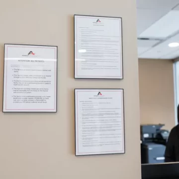 Wall-mounted informational posters in office | Ascent Emergency Room